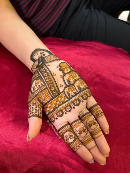 The full hand design, showing how the initial, elephants, and architectural elements come together to create a unique story.