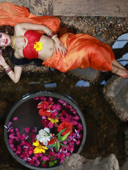 Another high-angle shot from our 'Lahu Munh Lag Gaya' series, this time incorporating a bowl of flowers in water. This composition adds color and a touch of serenity to the powerful theme.