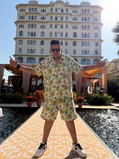 The grand facade of the hotel behind me. We play at some of the most beautiful locations.