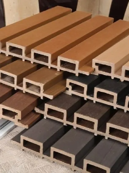 A collection of our WPC louver samples stacked to show the different colors and wood grain finishes we have in stock.