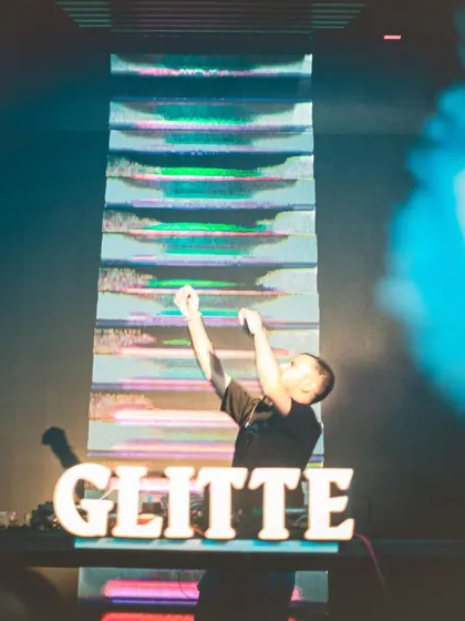 A powerful shot of me against a massive, glitchy visual display at Glitte.