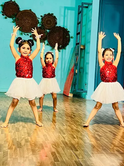 Three dancers striking a pose. They are learning to perform with confidence and flair.