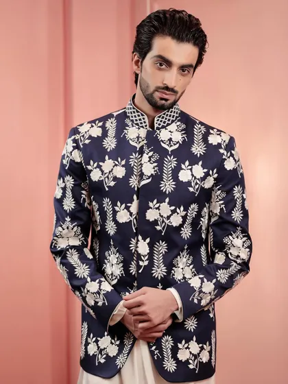 This navy and white embroidered jacket is a versatile classic. It can be dressed up for a wedding or worn to a festive dinner for a touch of elegance.
