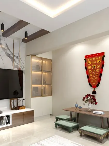 A unique living room setup with low seating and a traditional 'nettipattam' elephant caparison as wall decor, blending cultural elements with modern design.