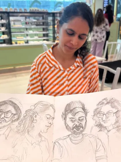 A fellow artist and 'model' for the day, looking down at the sketchbook page where I drew her. These interactions are a fun and informal part of our sketch walks.