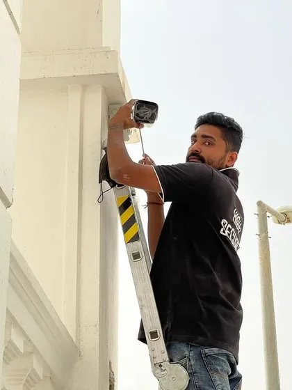 Another view of the installation process on a large home. I am focused on getting the camera angle just right for maximum security.
