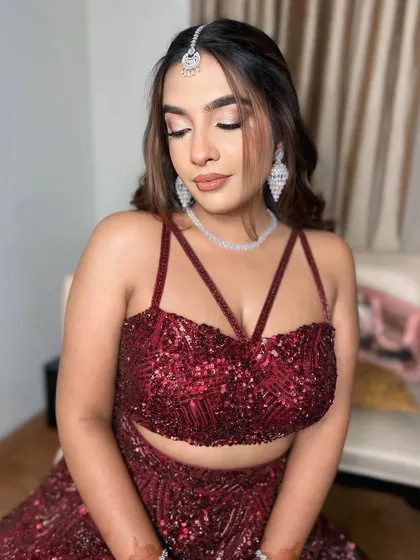 A close-up of the eye makeup for this red engagement look. The soft shimmer and defined lash line make her eyes sparkle.