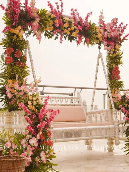 A beautifully decorated floral swing, perfect for post-ceremony photos or as unique seating for the bride and groom. The vibrant flowers create a stunning visual against any backdrop.