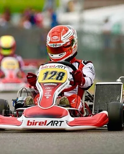 A Birel ART kart, number 128, on track. The iconic red and white livery is synonymous with speed and a legacy of winning in the world of karting.