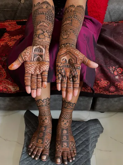 A full view of a bride's hands and feet, showing how the designs are coordinated. The peacock and palace theme is carried through from her arms to her legs.