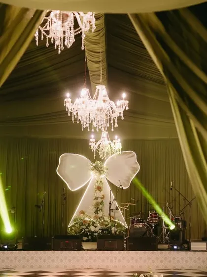 Pre-wedding events are a chance to be creative and bold. For this "Big Bow Affair," I designed a chic and dramatic stage with a statement illuminated bow, setting the perfect tone for a glamorous night of celebration.