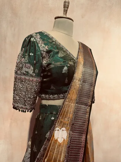 The Eden green blouse paired with a saree, showcasing its regal aesthetic.
