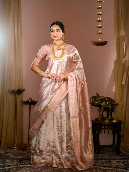 This look showcases timeless elegance. For this photoshoot, I created a soft, matte base with subtly defined eyes and a neutral pink lip to complement the delicate pastel saree and traditional gold jewelry, proving that classic can also be contemporary.
