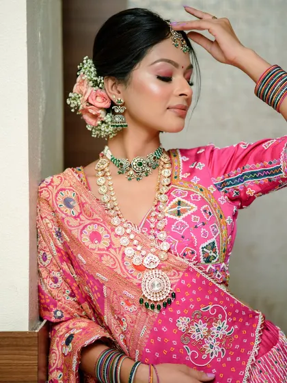 Another angle of this beautiful Gujarati bride. The floral bun is decorated with fresh roses, adding a touch of natural elegance to the traditional attire.