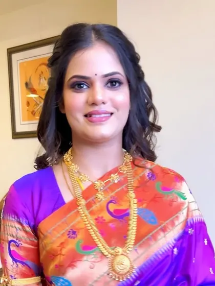 A full view of the reception look. The soft curls and glowing skin balance the dramatic eye makeup, creating a look that is both glamorous and graceful.