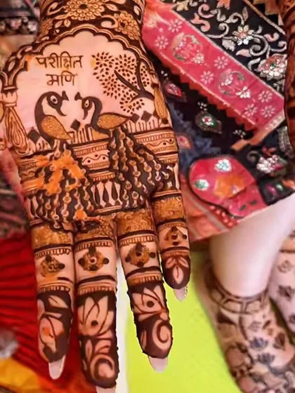A beautiful design featuring two peacocks and a name written in Hindi. This shows how we can blend traditional animal motifs with personal touches.