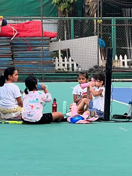 A quick water break for our young players. It's important to rest, rehydrate, and regroup during intense training sessions. These moments of camaraderie are just as important as the drills.