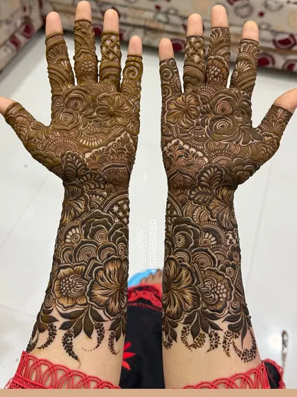 Another angle of the full bridal mehandi, showcasing the rich texture and coverage from the elbows to the fingertips.