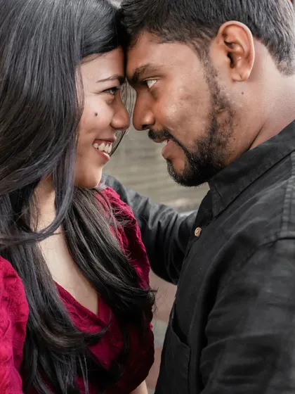 An intense and loving gaze shared between the couple, captured in a powerful close-up portrait.