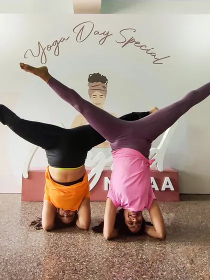 This is not just a yoga day post, it's a celebration of friendship and progress. My friend Monica and I started our yoga journeys together, and here we are, holding a split-leg headstand variation.