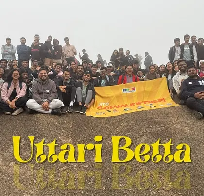 A massive group of adventurers who joined us for the Uttari Betta trek, all smiles after reaching the summit.