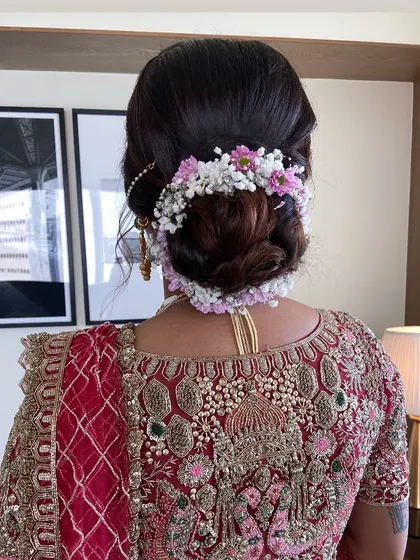 A closer look at the floral bridal bun, showcasing the placement of each flower to create a balanced and beautiful hair accessory.
