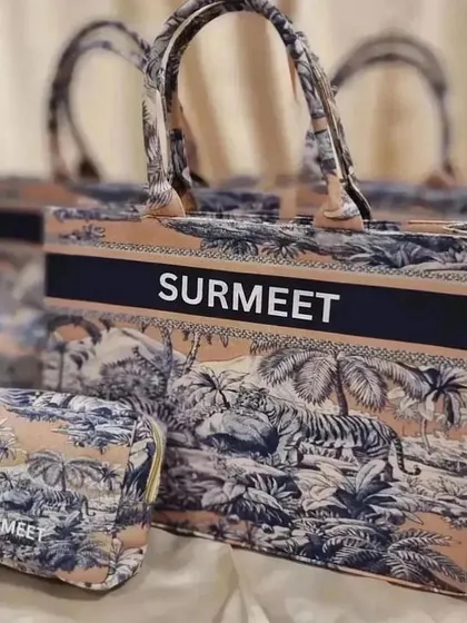 A close-up of the personalised tote bag and matching pouch from our anniversary gift set.