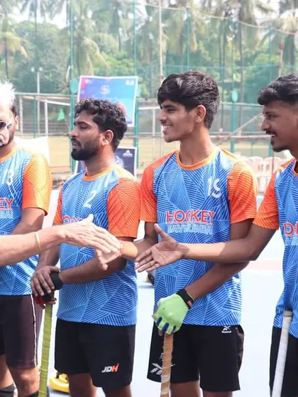 Our players greet an official with smiles and handshakes, demonstrating the positive and respectful attitude we carry into every competition.