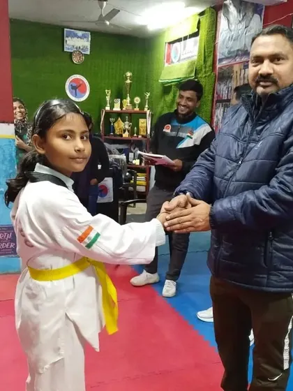 A proud moment for this young girl as she receives her new belt. I am happy to be part of her journey.