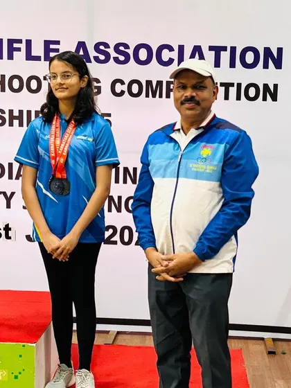 A moment of pride as our shooter stands on the podium next to me after winning a medal in the air rifle event.