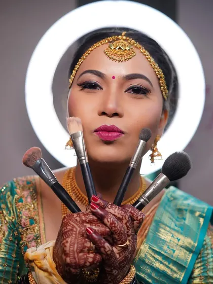 A fun shot of Arpitha with my makeup brushes, showing the playful and happy atmosphere I create.