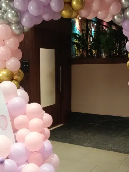 A welcome sign and balloon arrangement at the entrance for Kavya's 10th birthday party.