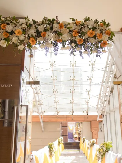 A beautiful floral archway at the entrance of the venue, welcoming guests to the Haldi celebration.
