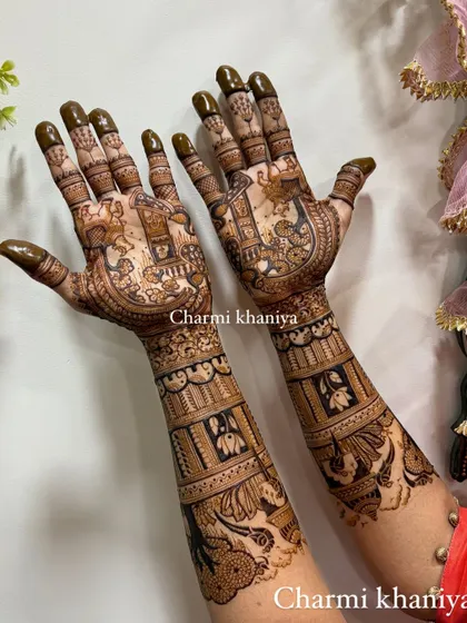 A trending design that is full of traditional charm. This mehendi features peacocks, elephants, and beautiful architectural elements.