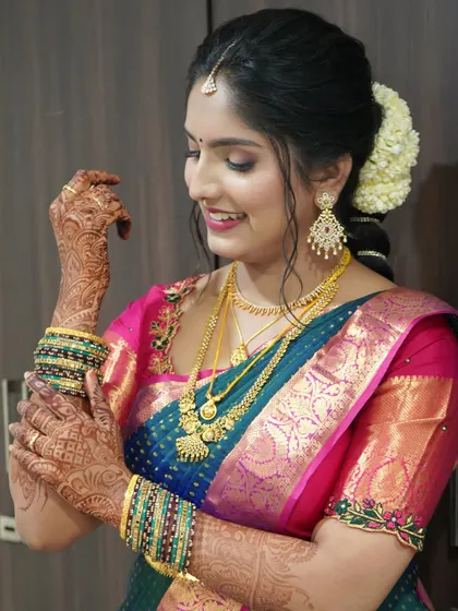 A beautiful shot showcasing the intricate henna design, the colorful bangles, and the flawless makeup.