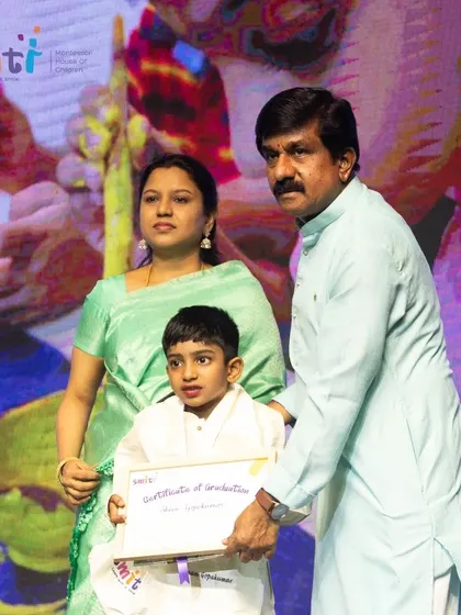 A boy receives his graduation certificate, ready to take the next step in his educational journey.