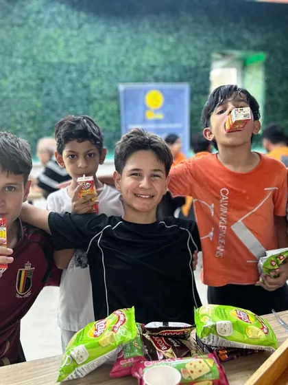 Snack time at summer camp! After a session of climbing and games, the kids refuel with healthy snacks and drinks, ready for the next adventure.
