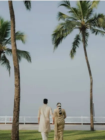 The couple walking away, showcasing the graceful back profile of the draped saree.