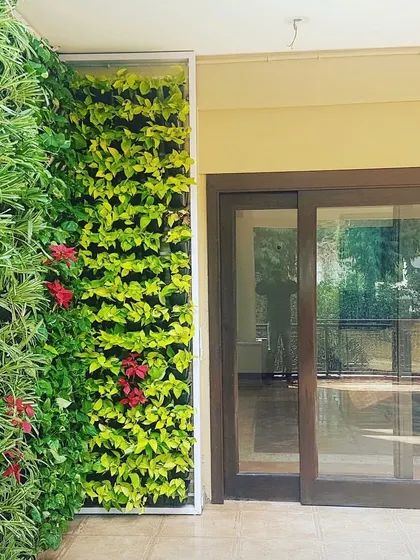 A vertical garden can be designed to fit any space. Here, I've installed a green wall next to a sliding glass door, bringing a vibrant wall of life to the entrance of the balcony.
