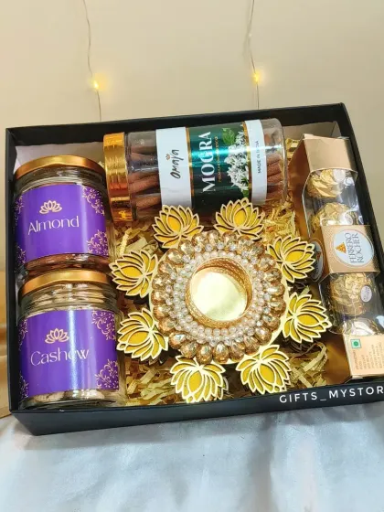 A classic and elegant choice for corporate gifting. This hamper features two jars of premium almonds and cashews, Ferrero Rocher chocolates, mogra-scented incense sticks, and a stunning lotus diya holder, all packed in a sleek black box.