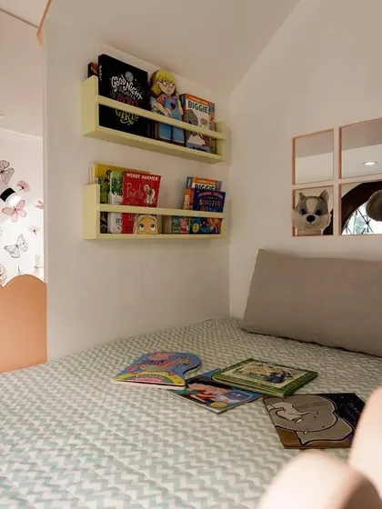Inside the lower bunk, I created a cozy reading nook with wall-mounted bookshelves. It’s a perfect example of how I design furniture to be multi-functional, creating special breakout spaces within a room.