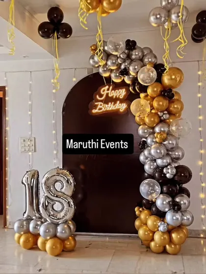 An 18th birthday deserves some glam. I designed this chic black, gold, and silver balloon arch against a dark backdrop, with a glowing neon "Happy Birthday" sign and giant light-up numbers to make the moment shine.