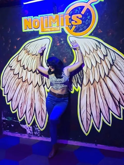 You don't need real wings to fly. A fun shot at a club, where I styled a leopard print crop top with high-waisted jeans for a casual party look.