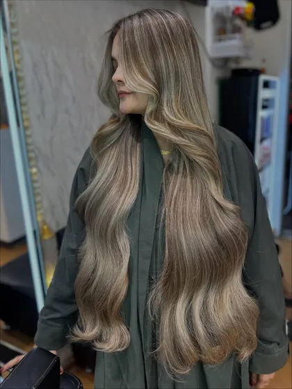 A profile shot of this incredible Icy Ash blonde transformation on extra-long hair. This is true hair artistry.