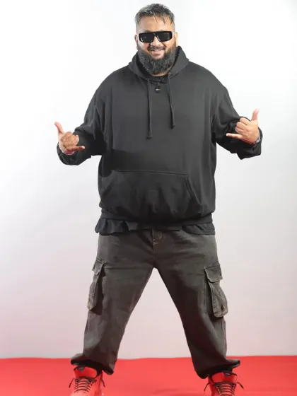 Rapper All OK in his signature hoodie, bringing his unique energy to the red carpet.