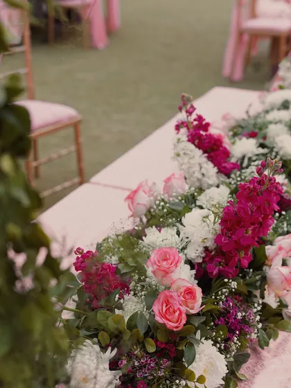 A close up of the floral arrangements used on the guest tables. We used a beautiful mix of pink roses, white chrysanthemums, and magenta snapdragons to continue the romantic theme throughout the venue.