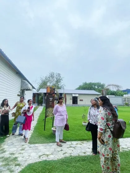 Students exploring the beautiful, green campus of Craft Village during their educational visit.