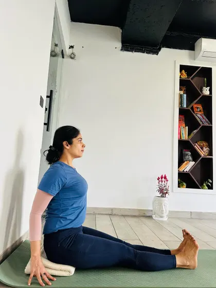 A folded blanket offers a middle ground between a soft bolster and a hard block. It provides gentle lift and support, helping to tilt the pelvis forward and maintain an upright spine in seated postures.