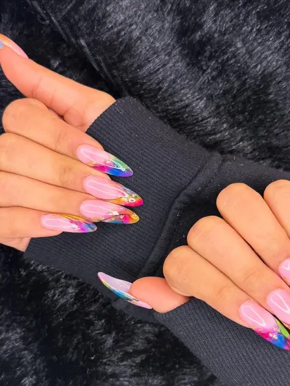 A long and dramatic set with a splash of color. This design features a sheer pink base with vibrant, rainbow-colored abstract art at the tips.