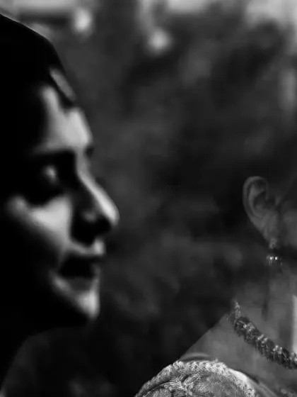 An artistic black and white double exposure. This photo blends the profiles of the bride and groom, symbolizing their two lives becoming one. It's a creative and emotional take on a couple portrait.